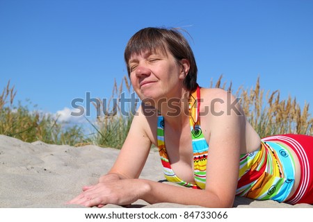 simple woman resting on the sand
