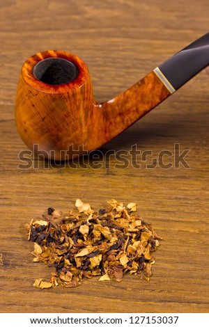 tobacco-pipe in rope,and tobacco on wooden background