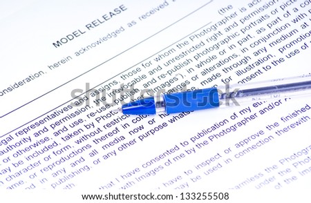 pen lying on the document of Model Release
