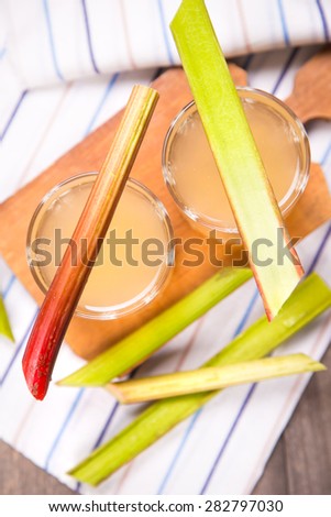 fresh fruit compote from pieplant in glasses on wooden background