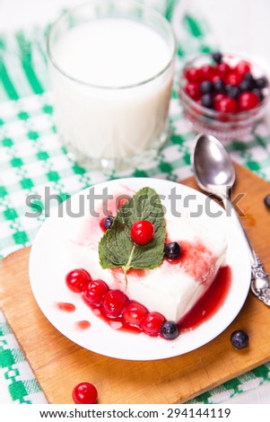 fresh curd with cherry, currant and sweet sauce on white plate