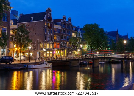 Amsterdam, Netherlands - July 31, 2014: View of the embankment and canal of Amsterdam at night.