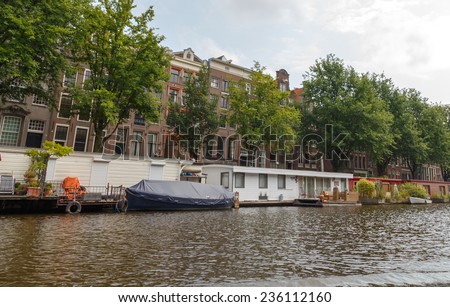 Amsterdam, Netherlands - July 29, 2014: Traditional house boat on the canals of Amsterdam. In Amsterdam, there are about 2,500 homes on the water.