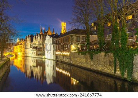 Bruges, Belgium - December 28, 2014: Green canal in Bruges. One of the most visited tourist attractions.
