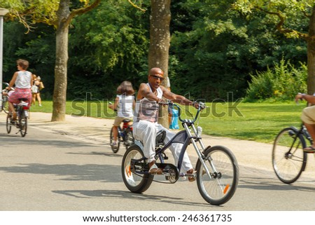 Amsterdam, Netherlands - August 5, 2014:  Cyclists on the cycling road Vondelpark in Amsterdam.