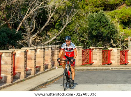 Tossa de Mar, Spain - September 12, 2015: Cyclist on the raising of the road. Cycling is one of the most popular in Europe.