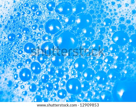 Soap bubbles macro with blue background