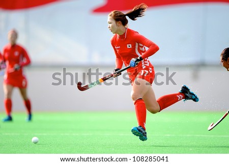 PATHUM THANI,THAILAND-JULY 3:Song Bo Rum (no.17 Red) of Korea runs with the ball during the WomenÃ¢Â?Â?s Junior AsiaCup Korea and Kazakhstan at QueenSirikit Stadium on July3,2012 in PathumThani,Thailand.