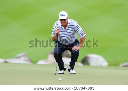 NAKHONPATHOM,THAILA ND-AUG 9:Peter Omalley of AUS watches lines up a shot hole 9 during day one of the Golf Thailand Open at Suwan Golf&Country Club on August 9, 2012 in Nakhonpathom Thailand