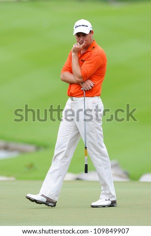 NAKHONPATHOM,THAILA ND-AUG 9:David Howell of ENG watches lines up a shot hole 9 during day one of the Golf Thailand Open at Suwan Golf&Country Club on August 9, 2012 in Nakhonpathom Thailand