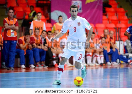 BANGKOK,THAILAND-NOVEMBER 06:Aleksandar Zivanovic (white) of Serbia runs with the ball during the FIFA Futsal World Cup between Kuwait and Serbia at Indoor Stadium Huamark on Nov6, 2012 in ,Thailand.