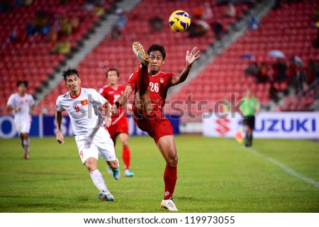 BANGKOK THAILAND-NOV 24:Aung Hein Kyaw of Myanmar (red) shoot the ball during the AFF Suzuki Cup between Vietnam and Myanmar at Rajamangala stadium on Nov24, 2012 in Bangkok,Thailand.