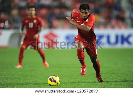 BANGKOK THAILAND-NOVEMBER 30:Sompong Soleb of Thailand (red) runs with the ball during the AFF Suzuki Cup between Vietnam and Thailand at Rajamangala stadium on Nov30, 2012 in Bangkok,Thailand.