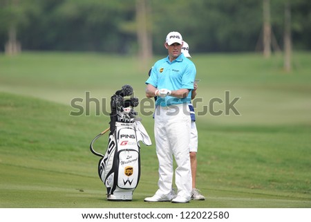 CHONBURI,THAILAND-DECEMBER 6: Lee Westwood of England watches lines up before a shot during hole 1 day one of the Thailand Golf Championship at Amata Spring Country Club on Dec 6,2012 in,Thailand.