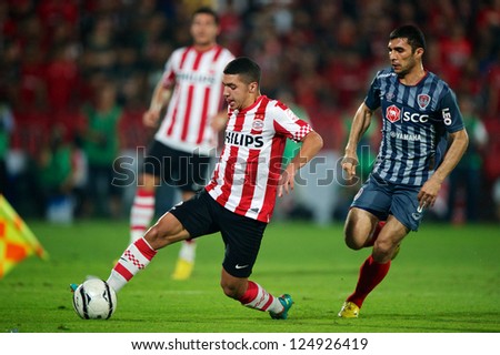 BANGKOK,THAILAND-JANUARY 8: Zakaria Bakkali (RED) of PSV in action during The AIA Champions Cup match between SCG Muangthong Utd. and PSV at SCG Stadium on Jan8 ,2012 in ,Thailand.