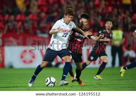 BANGKOK,THAILAND-JANUARY 27:Jung Woo-Young (L) of Jubilo Iwata in action during The Yamaha Invitation 2013 between SCG Muangthong Utd.and Jubilo Iwata at SCG Stadium on Jan27,2013 in,Thailand.