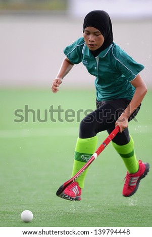 PATHUM THANI THAILAND-MAY 24:Henri of Kasetsart HC.control the ball during The PTT Thailand Hockey League between Kasetsart HC.and PTT Power at QueenSirikit Stadium on May 24,2013 in Thailand