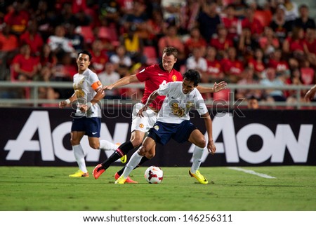 BANGKOK,THAILAND-JULY13:Teerasil Dangda(R)of Singha All Star XI in action during the friendly match between Singha All Star XI and Manchester United at Rajamangala Stadium on July13, 2013 in Thailand.
