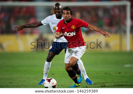 BANGKOK THAILAND-JULY13:Fabio (R) of Manchester United run with the ball during the friendly match between Singha All Star XI and Manchester United at Rajamangala Stadium on July13,2013 in Thailand.