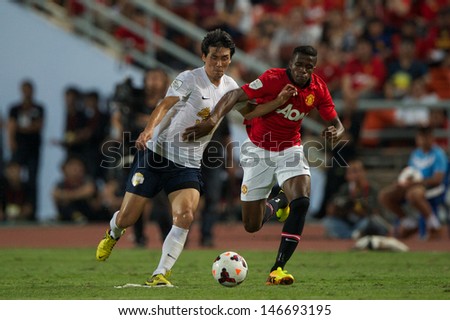 BANGKOK,THAILAND-JULY13:	Ri Kwang-Chon (L) of Singha All Star  in action during the friendly match between Singha All Star and Manchester United at Rajamangala Stadium on July13, 2013 in Thailand.