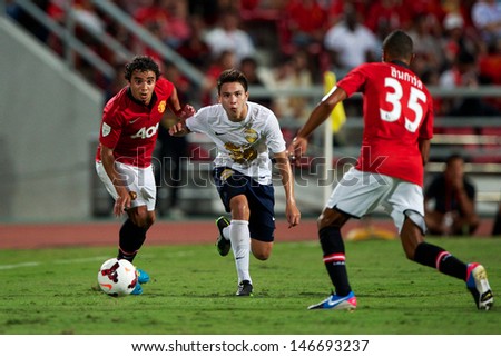 BANGKOK,THAILAND-JULY13: Jesse Lingard (L) of Manchester United in action during the friendly match between Singha All Star and Manchester United at Rajamangala Stadium on July 13, 2013 in Thailand.