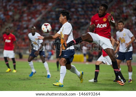 BANGKOK,THAILAND-JULY13: Danny Welbeck(R)of Manchester United in action during the friendly match between Singha All Star XI and Manchester United at Rajamangala Stadium on July 13, 2013 in Thailand.