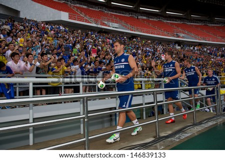 BANGKOK,THAILAND-JULY 16: Branislav Ivanovic of Chelsea FC throws footballs to fans during a Chelsea FC training session at Rajamangala Stadium on July 16, 2013 in Bangkok, Thailand.
