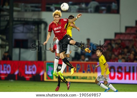 NONTHABURI THAILAND-MARCH 15:Kim Dong-Jin #6 (red) of Muangthong Utd in action during Thai Premier League between Muangthong Utd.and Police United at SCG Stadium on March 15, 2014,Thailand
