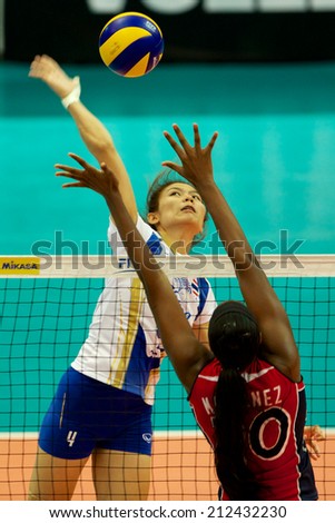 BANGKOK,THAILAND-AU GUST15:Thatdao Nuekjang (L)of Thailand spikes the ball during the FIVB World Grand Prix Thailand and Dominican Republic at Indoor Stadium Huamark on Aug.15, 2014 in Thailand.