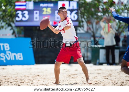 PHUKET,THAILAND-NOVEMBER 13:Nishioka Yoshiya no.11of Japan throws the football during Beach Flag Football Thailand and Japan during the 2014 Asian Beach Games at Saphan Hin on Nov 13,2014 in Thailand.