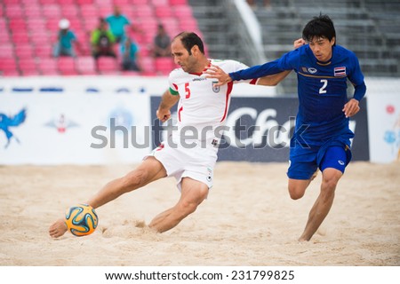 PHUKET THAILAND-NOVEMBER19:Ali Naderi Hosseinabadi (L)of Iran in action during the Beach Soccer match between Thailand and Iran the 2014 Asian Beach Games at Saphan Hin on Nov 19,2014 in Thailand