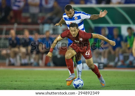 BANGKOK,THAILAND-July8:Chananan Pombupha(RED)of Thailand All Stars for the balln during The Reading FC Thailand Tour 2015 Thailand All Stars and Reading FC at National Stadium on July 8,2015,Thailand.