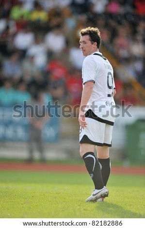 PATHUMTHANI,THAILAND-AUG,2:Former Liverpool Football Club and England striker.Robbie Fowler of MTUTD during in Toyota League Cup between KU and MTUTD at Thupatemee Stadium :Aug 2,2011.Pathumthani,Th.