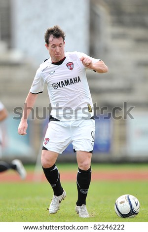 PATHUMTHANI,THAILAND-AUG,2:Former Liverpool Football Club and England striker.Robbie Fowler of MTUTD during in Toyota League Cup between KU and MTUTD at Thupatemee Stadium :Aug 2,2011.Pathumthani,Thailand.