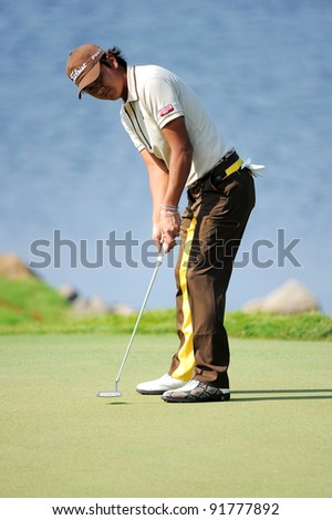 CHONBURI, THAILAND - DECEMBER 15: Hiroshi Iwata of Japan lines up a putt during day one of the Thailand Golf Championship at Amata Spring Country Club on December 15, 2011 in Chonburi, Thailand.