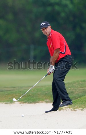 CHONBURI, THAILAND - DECEMBER 15: Jeev Milkha Singh of India plays a shot during day one of the Thailand Golf Championship at Amata Spring Country Club on December 15, 2011 in Chonburi, Thailand.