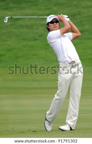 CHONBURI,THAILAND - DECEMBER 15: Kim Kyung-Tae of Korea (South) plays a shot during day one of the Thailand Golf Championship at Amata Spring Country Club on December 15, 2011 in Chonburi, Thailand.