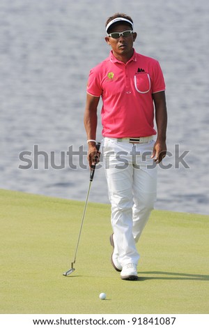 CHONBURI,THAILAND - DECEMBER 15: Thongchai JAIDEE of Thailand plays a shot during day one of the Thailand Golf Championship at Amata Spring Country Club on December 15, 2011 in Chonburi, Thailand.