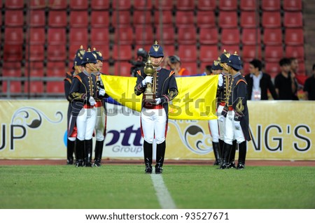 BANGKOK THAILAND-JAN15:Thai soldiers walk with trophy during opening ceremony at 41st King\'s cup football between Thailand(Y) and KoreaRep(R)at Rajamangala stadium on Jan15,2012 in Bangkok,Thailand.