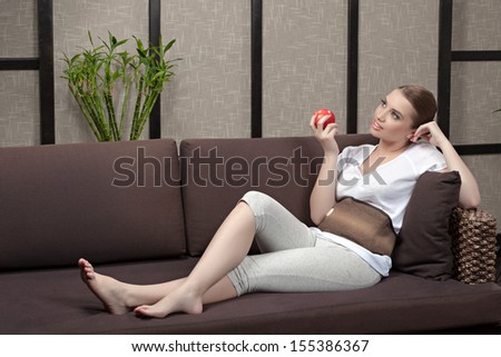 Relaxed young female getting a stone massage in a spa