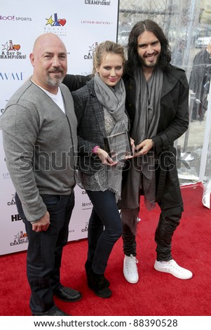 LOS ANGELES, CA - NOVEMBER 06: Russell Brand, Adam & Trina Venit arrive at Day Of Champions Benefiting the Bogart Pediatric Cancer Research Program at Sports Museum of Los Angeles on November 6, 2011.