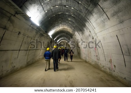 MAUTHAUSEN,AUSTRIA-MAY 10,2014:people with helmet visit the Gusen tunnel,a serie of secret tunnels near the concentration camp of mauthausen