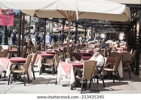 VERONA,ITALY-APRIL 26,2012:many people stop for a drink or lunch in the bar restaurant located in  Bra square in Verona during a sunny day.