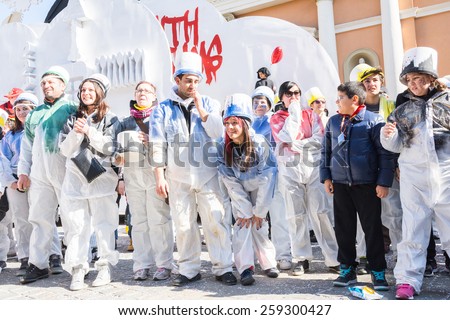 SAN GIOVANNI IN PERSICETO,BOLOGNA,ITALY-MARCH7,2015:funny people in colored carnival costume and masks celebrate at the traditional carnival of san giovanni in persiceto during a sunny day.