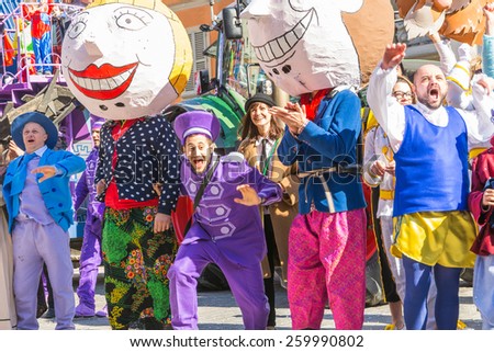 SAN GIOVANNI IN PERSICETO,BOLOGNA,ITALY-MARCH 7,2015:funny people in colored carnival costume and masks celebrate at the traditional carnival of san giovanni in persiceto during a sunny day.