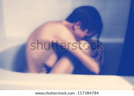 a very depressed person in the bathtub