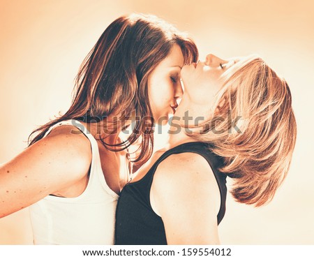 two women about to kiss each other vintage toned