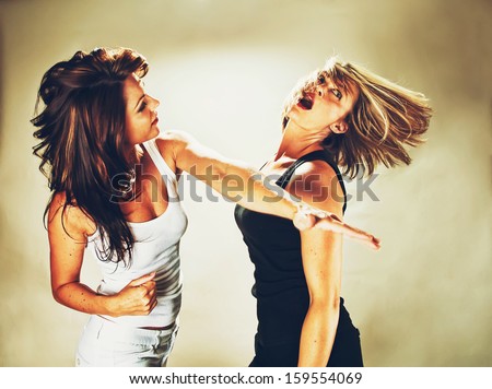 a woman hitting another woman vintage toned