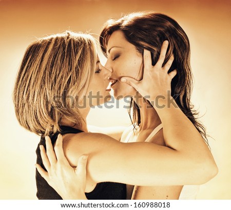 two women about to kiss each other