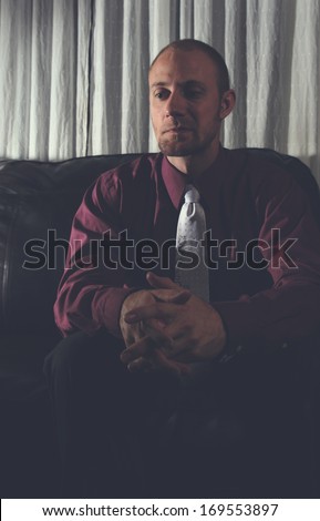 a man in deep thought, maybe depressed could be used for mental health brochures or ads